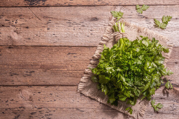 Fresh parsley as a cooking concept on an old wooden table