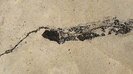 black paint on cracked concrete