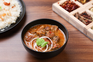 Traditional homemade Mutton curry from Asian cuisine. Chukhandar gosht. Spicy delicious meat beef curry. Bowl of tasty mutton roast Indian spices. side dish of Ghee rice, Appam, Parotta, Puttu