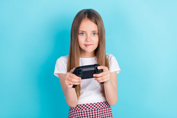 Photo of funny blond hair little girl playstation wear white t-shirt isolated on blue color background