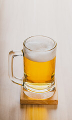 Glasses of light beer, cold craft beer in a glass on wood table