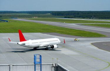 The car accompanies a passenger plane to the runway