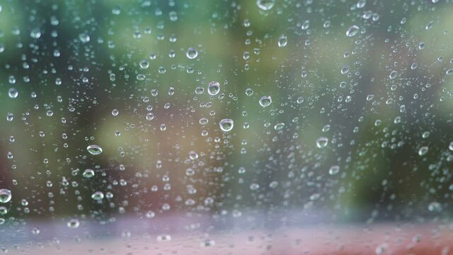 Rainy day behing the window in 4k slow motion 60fps