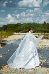 Fototapeta na wymiar Young bride posing near the river