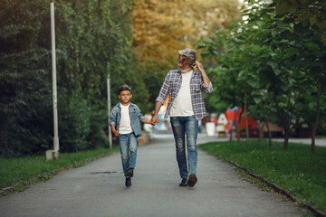 Fototapeta na wymiar Grandfather with grandchild walking in a summer park