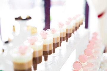 Delicious sweets on wedding candy buffet with desserts, cupcakes