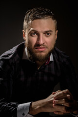 Portrait of young handsome serious man posing in studio