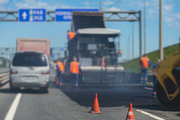 Process of asphalting and paving, asphalt paver machine and steam road roller during road...