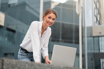 Businesswoman successful woman business person outdoor corporate building exterior. Pensive caucasian confidence professional business woman middle age