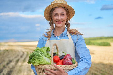 Woman farmer straw hat apron standing farmland smiling Female agronomist specialist farming agribusiness Happy positive caucasian worker agricultural field