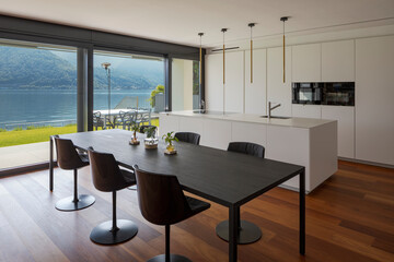 Interior of a modern apartment, kitchen and dining room stand together. High standing, nobody...