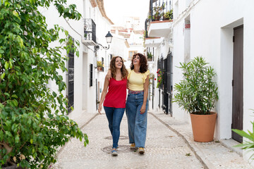 Horizontal view of couple of women traveling in Spain. Travel and holidays concept in summer.