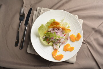 mixed raw smoked fish with fruit and salad dressing appetiser Peruvian cuisine menu