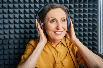 Hearing test at senior woman. Positive mature woman during hearing exam and audiometry at hearing...