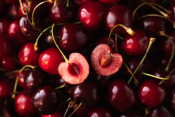 the cherry is close. a cut cherry berry with cuttings on top of other berries