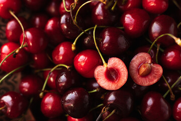 the cherry is close. a cut cherry berry with cuttings on top of other berries