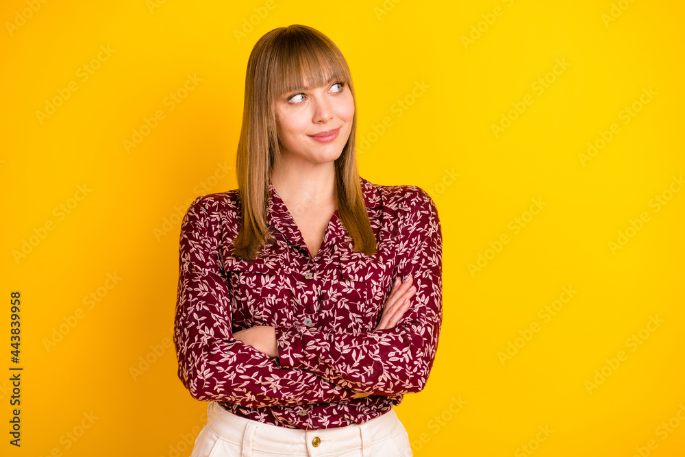 Wall mural Photo portrait of confident business woman smiling with crossed hands looking blank space isolated vibrant yellow color background