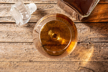 Fototapeta na wymiar Cognac drink on rustic wooden table. Top view