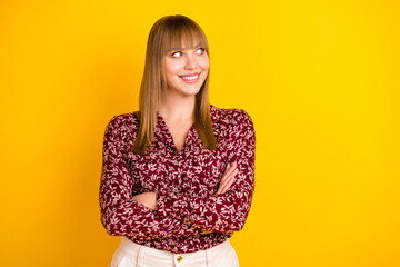 Photo portrait of young business woman smiling folded hands looking empty space isolated vibrant yellow color background