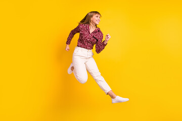 Full length body size photo jumping woman running fast looking copyspace isolated bright yellow color background