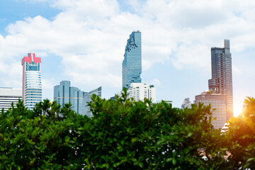 Aerial view with green tree of Bangkok modern high office buildings, condominium and skyscraper in Bangkok city downtown with sunset sky , Bangkok,Thailand