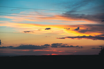 Fototapeta premium Incredibly beautiful sunset with a yellow-blue sky. Beautiful sky at sunset. Wonderful sunset by the ocean. The sea with a beautiful sky. Twilight at sea. Ocean. Sea with beautiful sunset. Yellow sky.