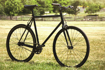 Fototapeta na wymiar fixie black bike with grass background