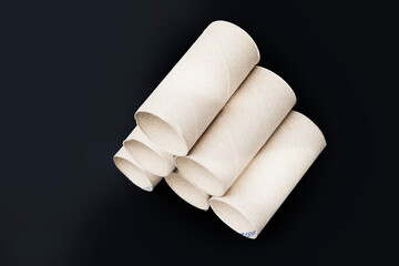 Toilet paper rolls without paper on dark background with copy space  - Clipping path