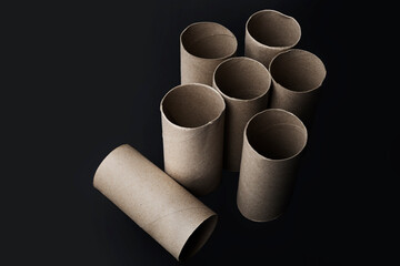 Toilet paper rolls without paper on dark background with copy space  - Clipping path