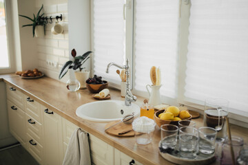 Interior of kitchen with ingredients for making lemonade on the table.
