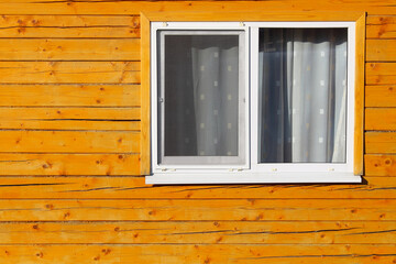 Double-glazed windows in a wooden house. Close-up. Background. Texture.