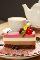 Piece of tasty mousse cake with   fresh berries on plate  