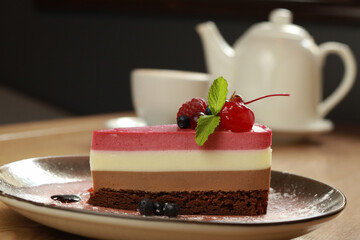 Piece of tasty mousse cake with   fresh berries on plate  