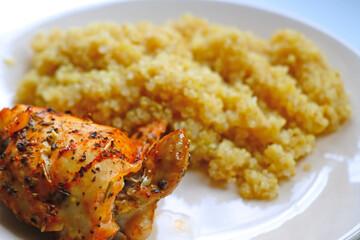 piece of fried chicken with porridge on a plate.
