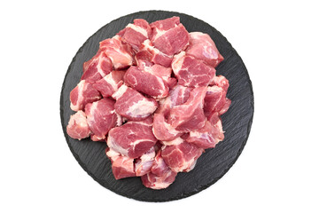 Raw pork pieces, ingredients for goulash, close-up, isolated on white background.