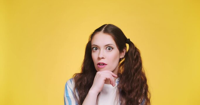 Attractive young thinking pondering woman feeling inspired and got flash incredible idea, isolated on yellow background. Fantasy and creativity eureka hand gesture concept thinking. Copy space blank