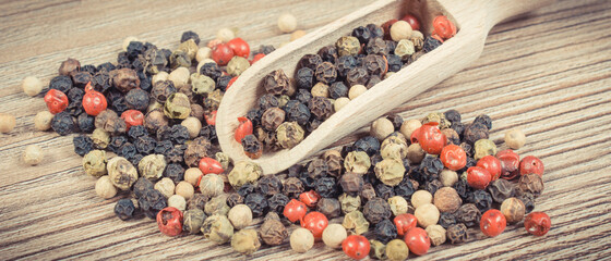 Colored pepper on wooden board. Spice using for cooking