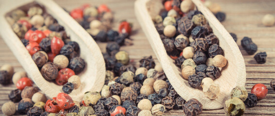 Colored pepper on wooden board as cooking spice
