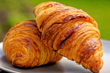 Close-up with fresh golden croissants on a plate