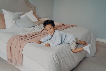 Happy little afro american kid enjoying playtime at home