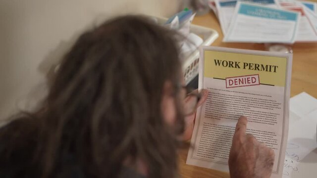 Frustrated Man With a Denied Work Permit Tears Apart The Document