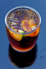 Cuba Libre or rum and cola drink with ice and lime