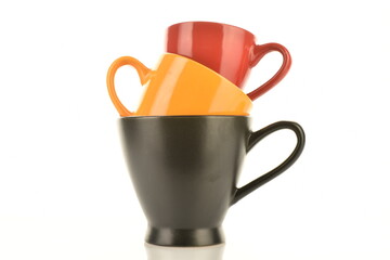 Three ceramic cups, close-up, isolated on white.