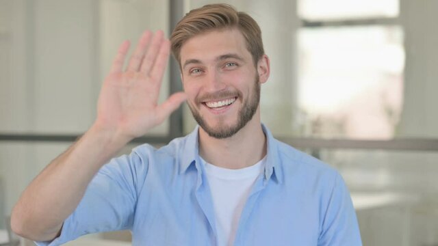 Portrait of Young Creative Man Waving, Welcoming