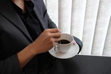 Closed up with asian businessman relax and break with a black coffee.