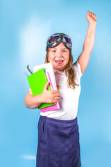 Back to school, pursuit of knowledge concept. A cute primary school girl in a white blue classic...