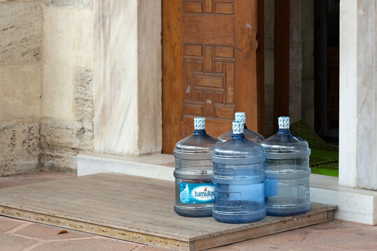 Karakoy, Istanbul, Turkey - May 31 2021: Plastic polycarbonate carboys left in front of an open door of a building. Delivered by a potable water service company.