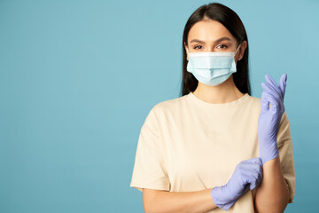 Beautiful brunette wearing protective gloves during quarantine