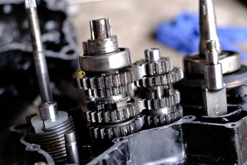 The gear system in the motorcycle engine is waiting for the mechanic to repair.