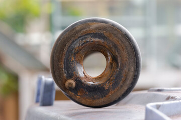Rusty broken shock absorber of a car from above